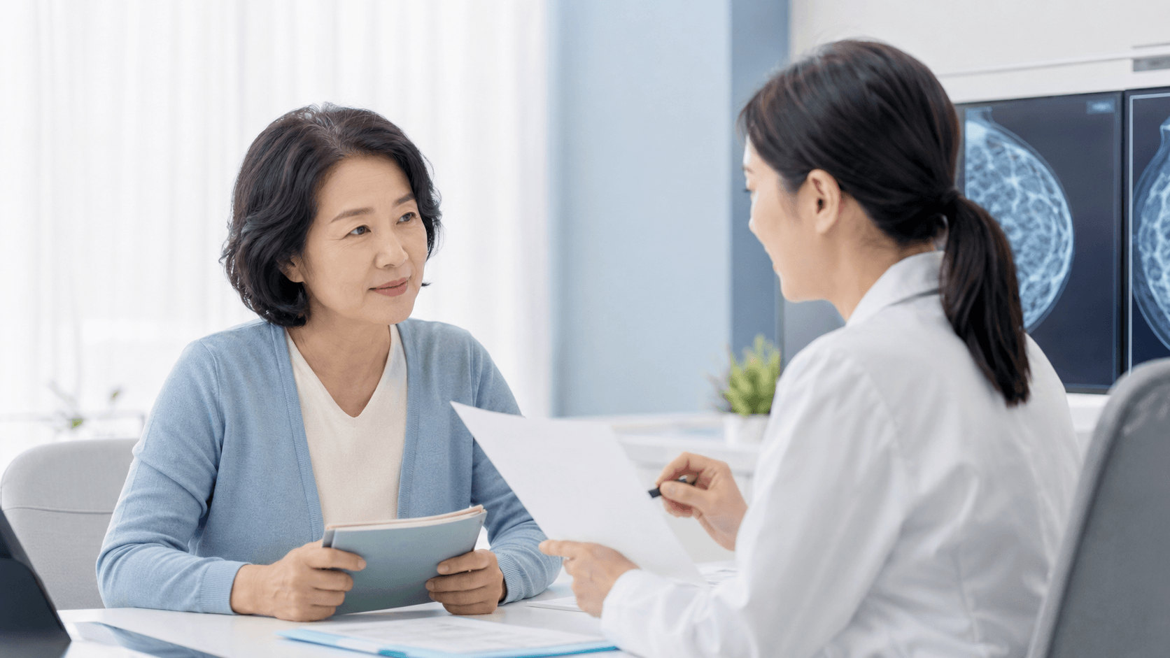 유방암 검진 상담을 받는 50대 한국인 여성과 의료진의 차분한 병원 상담 장면